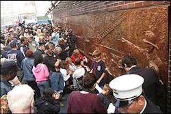 Family members and friends of firefighters who died in the Sept. 11 attacks gather in front of the memorial dedicated to the New York City Fire Department after the unveiling ceremony outside Engine 10/Ladder 10, June 10. Family members and friends of firefighters who died in the Sept. 11 attacks gather in front of the memorial dedicated to the New York City Fire Department after the unveiling ceremony outside Engine 10/Ladder 10, June 10.