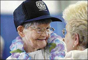 Louise &acirc;&euro;&DiacriticalTilde;&acirc;&euro;&DiacriticalTilde;Alice&acirc;&euro; Long receives birthday wishes from a friend during a surprise 100th birthday party held by the Capitol Heights Volunteer Fire Department on Saturday. Long has been a volunteer with the department for 70 years.