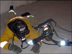 Photo 7: To completely remove the S.C.B.A. the firefighter should loosen the shoulder straps and remove the waist harness. They should then &apos;roll&apos; out of the S.C.B.A. by rolling over to the left.
