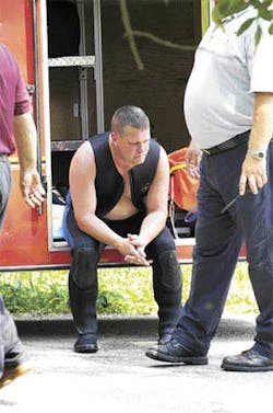 A member of the dive team sits silently after Anderson was pulled from the water. A member of the dive team sits silently after Anderson was pulled from the water.