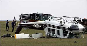 Chicago firefighters inspect the site of a helicopter crash, June 30.
