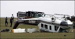 Chicago firefighters inspect the site of a helicopter crash, June 30. Chicago firefighters inspect the site of a helicopter crash, June 30.