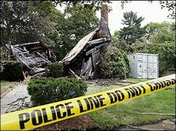 The burnt remains of a house in Peabody, Mass., is cordoned off by police tape July 6. The burnt remains of a house in Peabody, Mass., is cordoned off by police tape July 6.