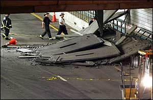 Firefighters inspect a section of ceiling in the Interstate 90 connector tunnel eastbound through Boston that collapsed onto the roadway and killed a woman passenger.