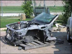 Photo 1: The entire structural front end of a vehicle from the base of the A-pillar located at a body repair shop. This is also known as the front clip. Photo 1: The entire structural front end of a vehicle from the base of the A-pillar located at a body repair shop. This is also known as the front clip.