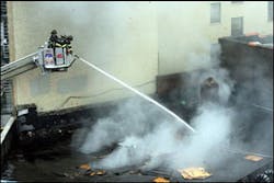 Firefighters pour water into the scene of a third alarm fire at 1575 Walton Avenue in the Concourse section of the Bronx borough of New York, the scene of a third alarm fire, Sunday, Aug. 27, 2006. Five firefighters were trapped and later rescued from inside the building after a partial collapse of the structure. One of them later passed away. Firefighters pour water into the scene of a third alarm fire at 1575 Walton Avenue in the Concourse section of the Bronx borough of New York, the scene of a third alarm fire, Sunday, Aug. 27, 2006. Five firefighters were trapped and later rescued from inside the building after a partial collapse of the structure. One of them later passed away.