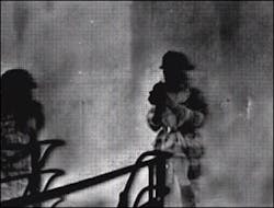 A supervisor monitoring a training burn can watch firefighters standing and walking because he is equipped with a TI. The white cloud surrounding the firefighters is superheated gases, indicating that the firefighters are ignoring basic safety as well as warning signs. A supervisor monitoring a training burn can watch firefighters standing and walking because he is equipped with a TI. The white cloud surrounding the firefighters is superheated gases, indicating that the firefighters are ignoring basic safety as well as warning signs.