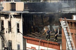 Firefighters stand on the roof of a damaged structure at the scene of an early morning apartment fire, in Union City, N.J., Saturday, Sept. 9, 2006. One firefighter was killed and four injured. Firefighters stand on the roof of a damaged structure at the scene of an early morning apartment fire, in Union City, N.J., Saturday, Sept. 9, 2006. One firefighter was killed and four injured.