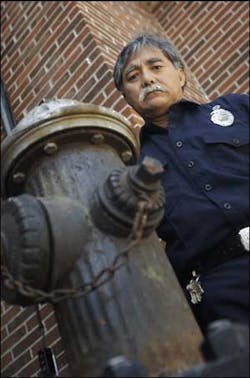Firefighter Robert Watanabe of the L.A. County Fire Department with one of the few fire hydrant that survived the 9-11 World Trade Center disaster.
