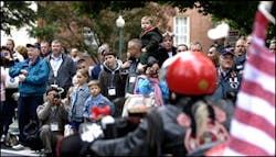 Families of fallen firefighters take pictures as the motorcyclists arrive on the campus of the National Fire Academy. Families of fallen firefighters take pictures as the motorcyclists arrive on the campus of the National Fire Academy.