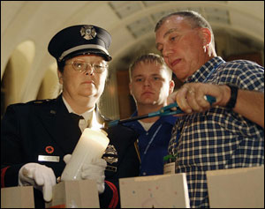 A candle is lit in honor of a fallen firefighter.