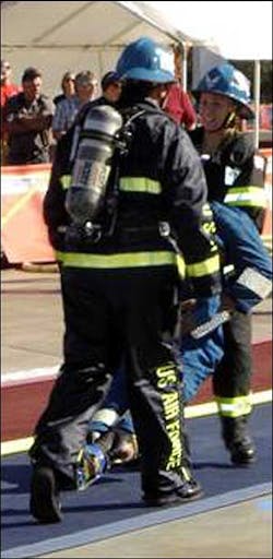 Shenah Groom carries a 175-pound 'victim' to the finish line during the tandem portion of the World Firefighters Combat Challenge held Nov. 7 to 11 in Henderson, Nev. Shenah Groom carries a 175-pound 'victim' to the finish line during the tandem portion of the World Firefighters Combat Challenge held Nov. 7 to 11 in Henderson, Nev.