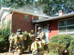 Photo 4. Volunteer Deputy Chief Charles Bailey and the first due companies prepare to enter the dwelling.
