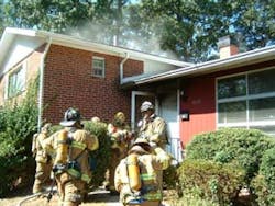 Photo 4. Volunteer Deputy Chief Charles Bailey and the first due companies prepare to enter the dwelling. Photo 4. Volunteer Deputy Chief Charles Bailey and the first due companies prepare to enter the dwelling.