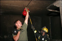 The author uses a set of kettlebells in a similar fashion to a firefighter performing overhaul.