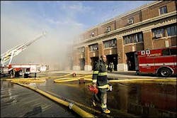 A firefighter walks in front a burning mattress supply building in Plainfield, N.J., Dec. 12. A firefighter walks in front a burning mattress supply building in Plainfield, N.J., Dec. 12.