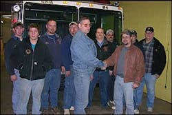 Niles English, President of Laceyville&apos;s Good Will Fire Company, front left, shakes hands with Chris Kemmerling, President of the Clover Volunteer Fire Company in Schuylkill County Wednesday night when Laceyville donated its 1987 KME pumper (seen behind the group) to Clover.