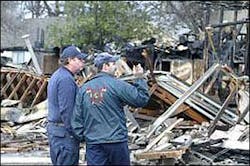 The Denison fire marshal, left, talks with the state fire marshal about a fire on Crockett Avenue in Denison. The Denison fire marshal, left, talks with the state fire marshal about a fire on Crockett Avenue in Denison.