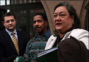 Ellreese N. Daniels, center, stands between his lawyer, Tina Hunt, and federal investigator Thomas Krzyzanek, after appearing in Federal Court, Jan. 4.