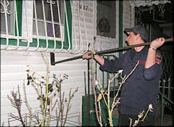firefighter uses the homemade window bar forcible entry tool designed by FDNY Ladder 126.