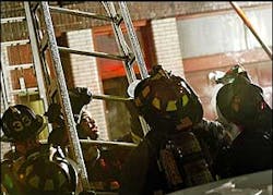 Firefighters struggle with a ladder as they work a fire on Endicott Street in the North End Thursday night. Firefighters struggle with a ladder as they work a fire on Endicott Street in the North End Thursday night.