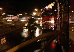 A firefighter walks past several fire engines, Feb. 25.
