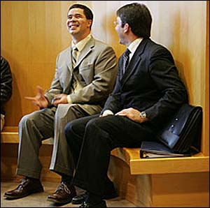 Isaac Feliciano (left) shares a laugh with one of his lawyers, William Maniatis.
