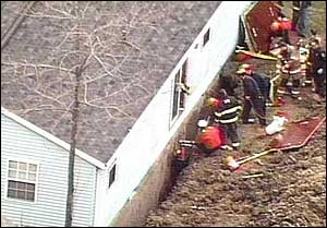 Rescue crews work to free a construction worker trapped in a trench in Summit County.