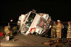 The truck was responding to a crash when it was struck from behind, injuring four firefighters.