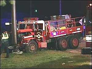 Two firefighters were hospitalized after a car slammed into their brush truck.