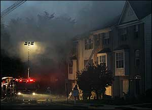 Firefighters prepare to enter a burning townhouse as they joined over 90 other firefighters.