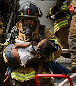 Racine firefighter James Mikulecky carries Maykaylee Smith, 4, from her burning home, May 2. Racine firefighter James Mikulecky carries Maykaylee Smith, 4, from her burning home, May 2.