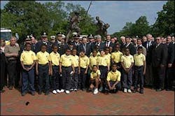 Firefighters pose with a group of students in front of the Maryland Fire Rescue Services Memorial, May 17.