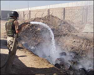 Shifflett douses a trash while stationed in Mosul, Iraq.