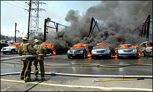 Los Angeles firefighters try to extinguish a fire at a warehouse in Los Angeles on Sunday May 27, 2007.