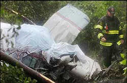 A Canton, Mass. firefighter walks past the wreckage of a single-engine aircraft in a wooded area in Canton, June 4. A Canton, Mass. firefighter walks past the wreckage of a single-engine aircraft in a wooded area in Canton, June 4.