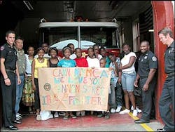 Youths presented the crew at Engine 6 with a banner they made to show their sympathy. Youths presented the crew at Engine 6 with a banner they made to show their sympathy.