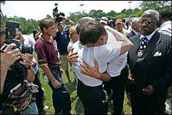 Chief Rusty Thomas embraces a colleague after a news conference where officials announced the names of the nine firefighters who died in the Sofa Super Store fire. Chief Rusty Thomas embraces a colleague after a news conference where officials announced the names of the nine firefighters who died in the Sofa Super Store fire.