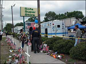People mourn the fallen firefighters at the scene of the blaze.