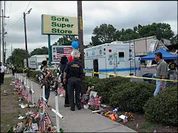 People mourn the fallen firefighters at the scene of the blaze. People mourn the fallen firefighters at the scene of the blaze.