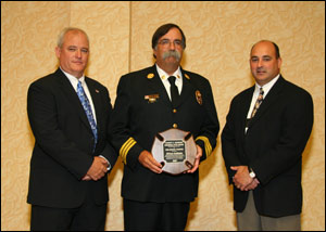 Chris Neal, Director Fire Protection Publications (left); Chief Billy Goldfeder; and Jeff Morrissette, IFSTA Board President.
