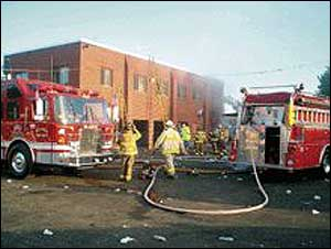 Firefighters work at the scene of a blaze that gutted the two-story section of the Glasco Firehouse.