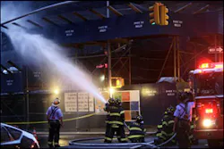 Firefighters spray water on smoldering debris that fell off the Deutsche Bank building during a fire at ground zero in New York, Saturday, Aug. 18, 2007.