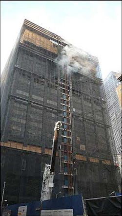 Smoke rises from the Deutsche Bank Building, center, bordering ground zero in New York, Aug. 18.
