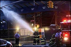 Firefighters spray water on smoldering debris that fell off the Deutsche Bank building during a fire at ground zero, Aug. 18. Firefighters spray water on smoldering debris that fell off the Deutsche Bank building during a fire at ground zero, Aug. 18.