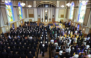 Firefighters walk down the aisle before the funeral