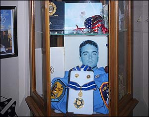 This cabinet with memories of a fallen hero is located in the Carlo home.