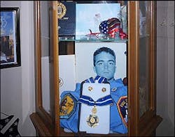 This cabinet with memories of a fallen hero is located in the Carlo home.