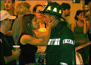 Amy Mullane prepares to kiss her husband, Captain Neil Mullane Jr. of Ladder 14, at the scene of the four-alarm fire that claimed the lives of two firefighters.