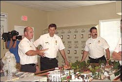 Charleston Chief Rusty Thomas, center, and Assistant Chief Robert O&apos;Donald listen to Montgomery County Assistant Chief Greg DeHaven, far left, during training.